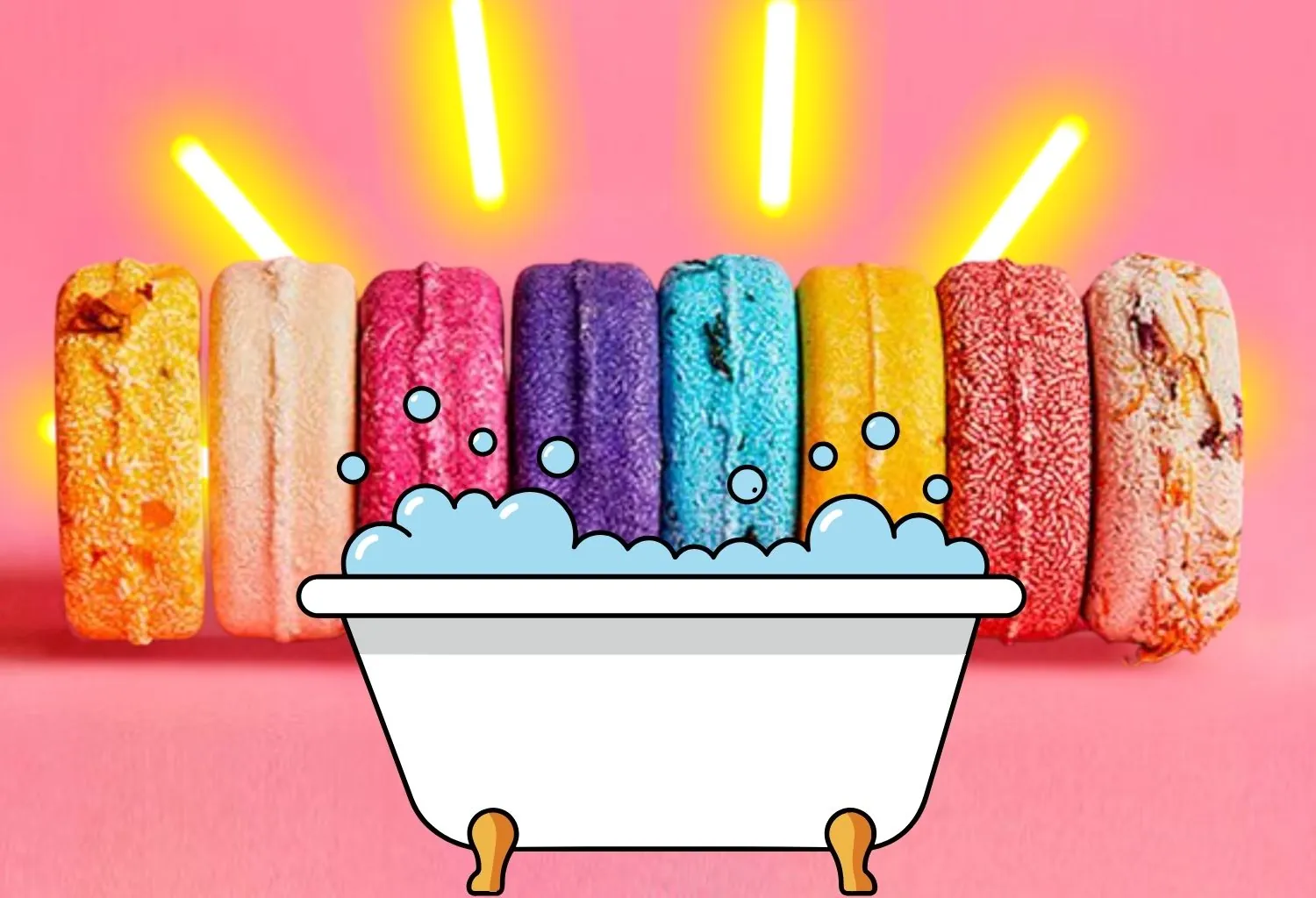 Bombas de baño de colores sobre fondo rosa junto a una ilustración de bañera con espuma.