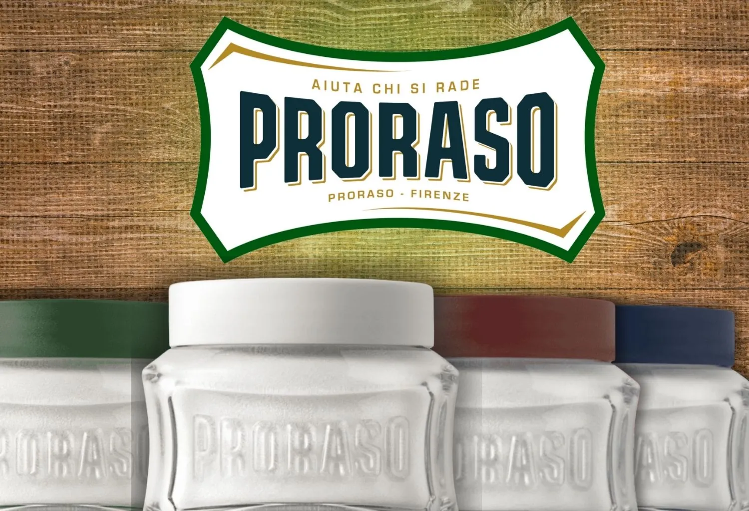 Colección de cremas de afeitar Proraso con diferentes líneas de color sobre fondo de madera rústica.