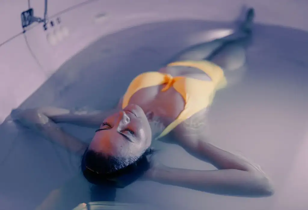 Mujer relajándose en baño de spa con tratamiento de bienestar y flotación