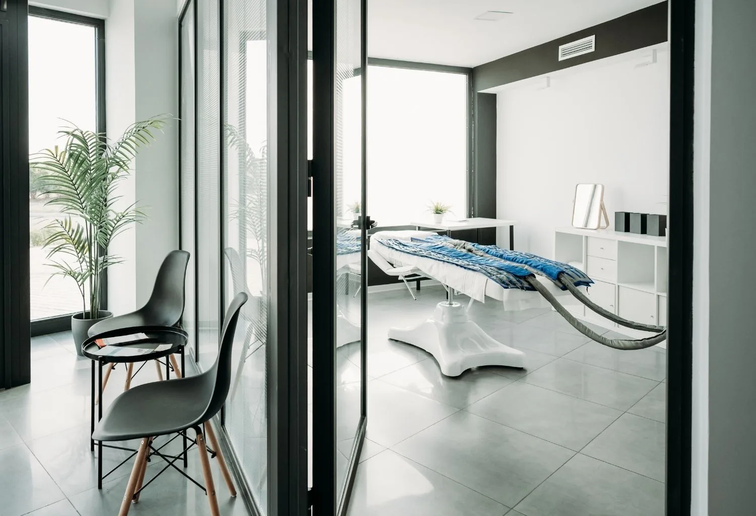 Interior de una clínica médico-estética moderna con sala de tratamientos y equipamiento profesional en una ciudad mediana española.