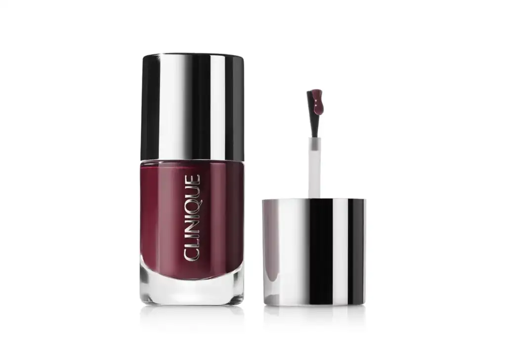 Esmalte de uñas Clinique en tono burdeos Esmalte de uñas Clinique en color burdeos con el aplicador abierto sobre fondo blanco, mostrando el envase y el tono del producto.