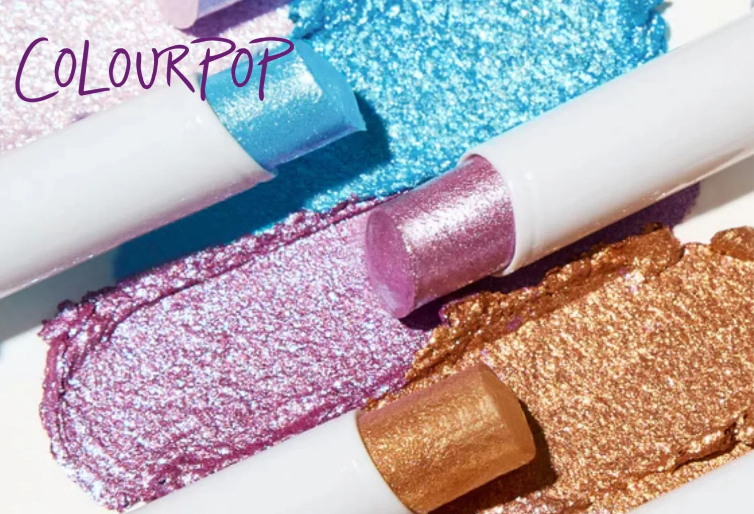 ColourPop Jelly Much Eyeshadow Stick en tonos azul, rosa y dorado con acabado brillante